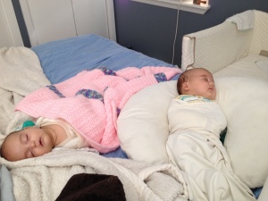 twins babies sleeping on bed